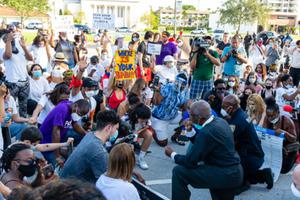 Protesters kneel in prayer in Coral Gables, Florida on May 30, 2020. 