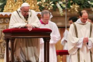 Pope Francis prays at Christmas Mass at St. Peter's Basilica on the evening of Dec. 24.
