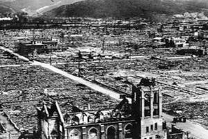 An aerial view of Our Lady of the Assumption Church after the Aug. 6, 1945, bombing. A small group of priests can be seen standing in the road in front of the church. 