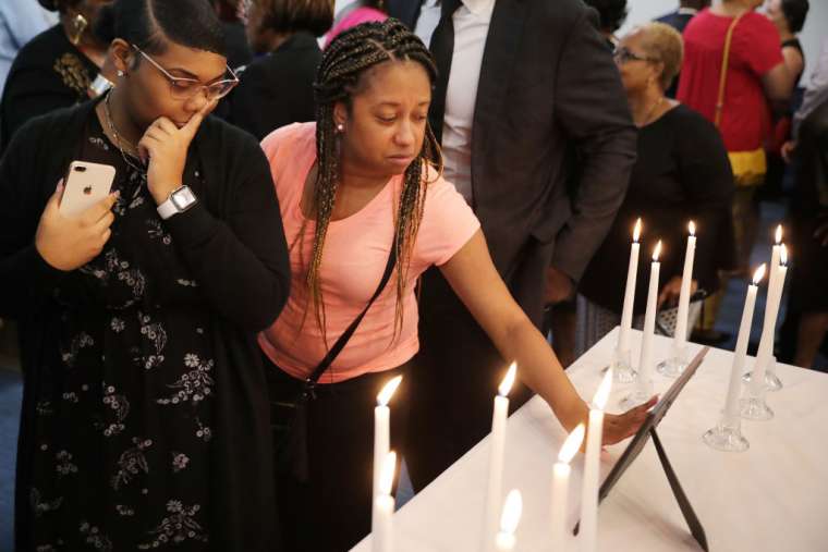 Dashae Wade (L) and Candace Grimes attend a memorial service at Piney Grove Baptist Church in Virginia Beach, Va., June 2, 2019. 