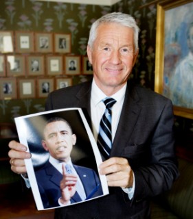 Thorbjoern Jagland, chairman of the Norwegian Nobel Committee, holds a picture of President Obama Oct. 9.