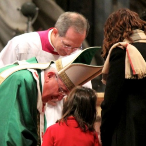 Pope Francis greets a little girl and her mother at Sunday Mass.