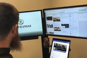 Above, Franciscan Father Richard Goodin ‘going over my social media world,’ with screens for video uploading and Twitter, Facebook and Instagram feeds. The iPad has the province’s @becomeafriar Facebook page.
Below, one of the social-media features for the Carmelite Sisters of the Most Sacred Heart of Los Angeles: a profile of a sister and the story behind her name; Father Goodin records a video of Franciscan Father Paul Walsman being interviewed by Franciscan Father Roger Lopez.  ‘We were asking him to give advice to young friars, as he was 90-plus years old at the time,’ Father Goodin said; and a Dominican friar prays.


