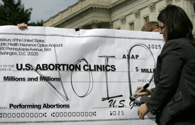 Kristan Hawkins, executive director of Students for Life, voids a mock check during a Sept. 10 news conference on Capitol Hill against the inclusion of abortion in any health-care reform proposal.