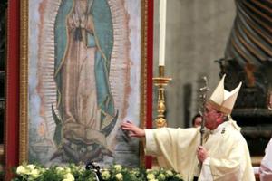 Pope Francis touches an image of Our Lady of Guadalupe at St. Peter's Basilica Dec. 12, 2014.