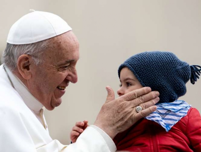 Pope Francis blesses a child during his weekly General Audience, 2019. 