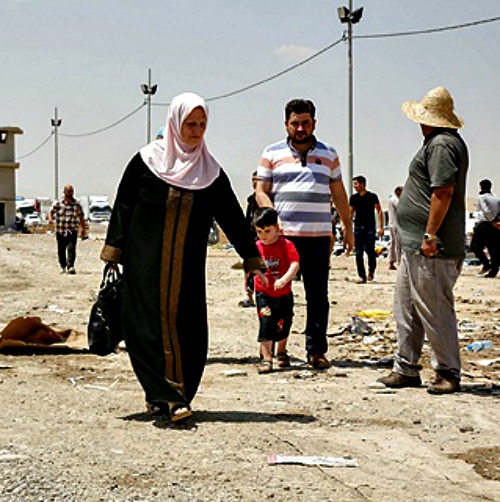 A family at the Khazair checkpoint after fleeing from Mosul, Iraq, in June.