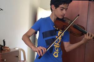 Above and below, Aboud Kaplo, a 14-year-old Syriac Orthodox refugee from Aleppo, Syria, plays the violin on loan to him from the renowned Bate Collection of Musical Instruments at the Faculty of Music at Oxford, in England. He and his family hope to immigrate to Australia from Lebanon, where they have sought refuge. 