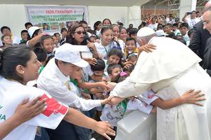 Pope Francis is greeted by a crowd at Padre Aldamiz International Airport in Puerto Maldonado, Peru, Jan. 19.