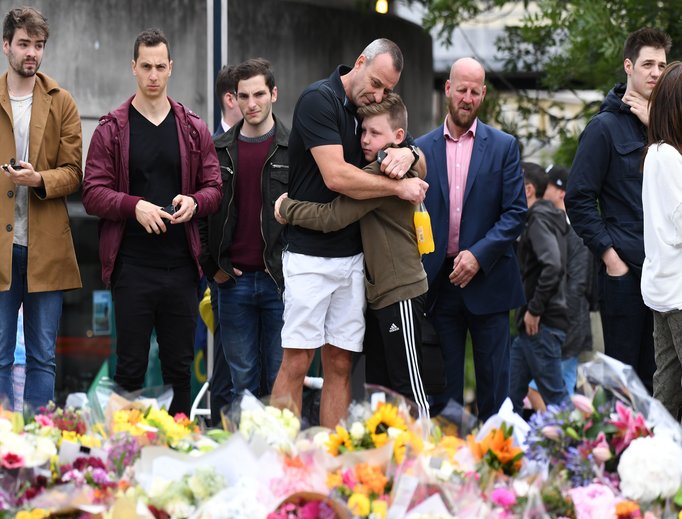 Members of the public mourn before a makeshift memorial near London Bridge June 5.