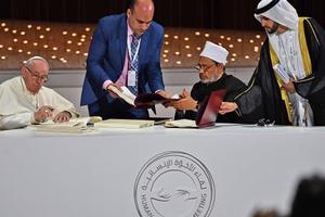 Pope Francis and Egypt's Azhar Grand Imam Sheikh Ahmed al-Tayeb (second from right) sign documents during the Human Fraternity Meeting at the Founders Memorial in Abu Dhabi Feb. 4.