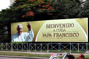 A vintage American car is driven past a poster of Pope Francis in Revolution Square on Sept. 16 in Havana, Cuba. Pope Francis is due to make a three-day visit to Cuba from Sept. 19, where he will meet President Raul Castro and hold Mass in Revolution Square before traveling to Holguin, Santiago de Cuba, El Cobre and onwards to the United States.
