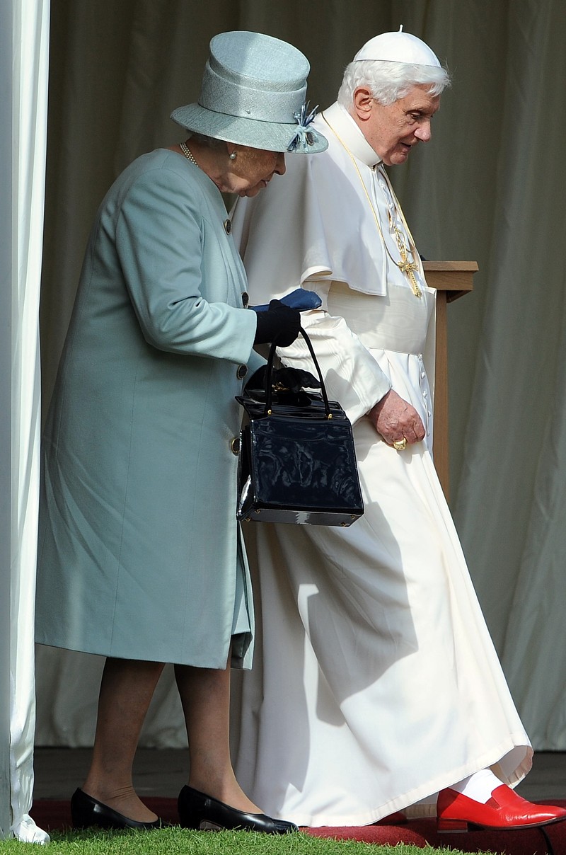 Britain's Queen Elizabeth II and Pope Benedict XVI walk through the gardens at the Royal Palace of Holyroodhouse in Edinburgh, Scotland, Sept. 16.