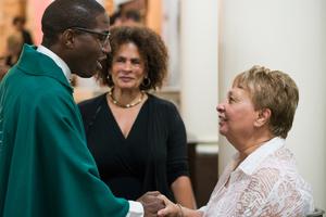Father Emmanuel Mulenga, a Missionary Oblate of Mary Immaculate, greets a parishioner at St. Augustine Catholic Church, where Father Mulenga is pastor, in New Orleans.