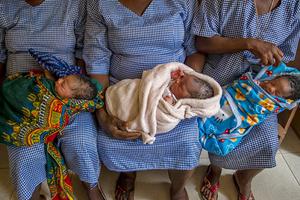 Traditional birth attendants hold newborns at the Buesu Community Health Center in Buesu Village, Sierra Leone. Catholic Relief Services provided training for the attendants to improve their knowledge and skills for safe newborn delivery. In new Trump administration policy, more funding will be available to pro-life organizations that work overseas.