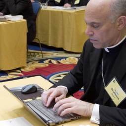 Bishop Salvatore Cordileone of Oakland, Calif., works on a laptop during the annual fall meeting of the U.S. Conference of Catholic Bishops Nov. 15 in Baltimore.