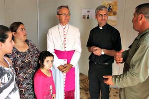 From top: Bishop Francesco Cavina of Carpi, Italy, meets with a Syriac Orthodox family who have been in the Dawudiya Refugee Camp near Duhok for 14 months. Haney, an 86-year-old Syriac Catholic, was kidnapped along with her son by Islamic State forces. After being released, they fled to Duhok then to Dawudiya, in Iraqi Kurdistan. Sadalla and his family fled from his town outside Mosul to escape from ISIS. They have taken refuge at the catechesis center in Mangesh for more than two years. ‘God willing, we’ll be able to go back to our home town soon. Until ISIS invaded, we lived with Muslims and Yazidis without any problems.’ Illuminated crosses adorn almost every caravan at the Asti 2 refugee camp in Ankawa, Erbil, Iraq, the largest Christian camp in Kurdistan.