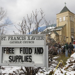 A sign is seen outside of St. Francis Xavier Church, which has become the main center for tornado victims to get help after the devastating tornadoes hit the area.
