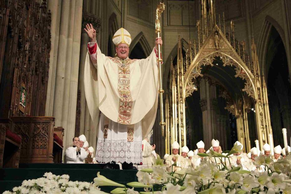 Archbishop Timothy Dolan acknowledges applause from the crowd during his installation Mass at St. Patrick's Cathedral in New York.