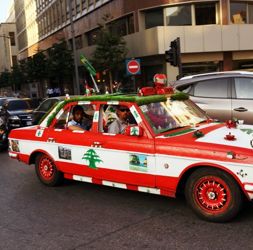 A car decorated in the colors of the Lebanese flag drives down a street in downtown Beirut, Lebanon, on June 23.