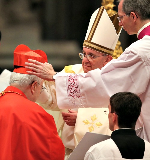 Cardinal Gualtiero Bassetti receives his biretta from Pope Francis during a consistory at St. Peter's Basilica on Feb. 22.
