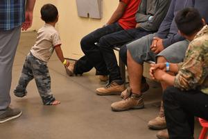 Young children are shown with their families at the U.S. Customs and Border Protection Facility in Tucson, Arizona, during a visit by First Lady Melania Trump June 28. 