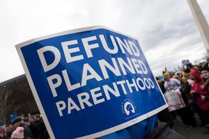 March for Life sign calls for the defunding of Planned Parenthood.