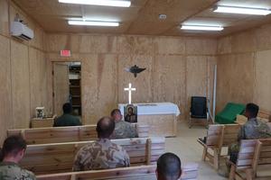 Father Michael Creagan, shown below holding up the jaguar mascot of the Catholic school at St. Joseph parish in West St. Paul, Minnesota, made sure soldiers in Afghanistan had access to Mass (his Mass kit is shown below) and adoration (shown above).