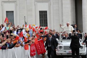  Pope Francis waves at pilgrims from China at a general audience in St. Peter’s Square. 