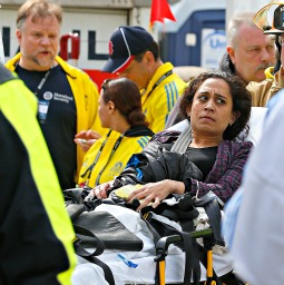A woman is loaded into an ambulance after she was injured by one of two bombs exploded during the 117th Boston Marathon near Copley Square on April 15 in Boston.