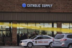 Authorities investigate the scene at Catholic Supply retail store where a gunman went into the religious supply store, sexually assaulted at least one woman and shot a woman in the head Nov. 19 in Ballwin, Missouri. 