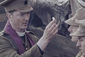 Above, Father Willie Doyle (portrayed by Brian Milligan) distributes Communion to soldiers on the battlefield in Bravery Under Fire