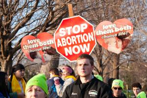 Students carry signs during March for Life, 2019.
