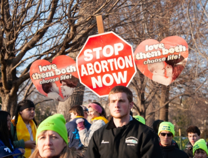 Students carry signs during March for Life, 2019.
