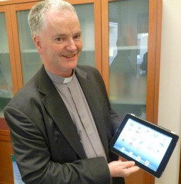 Msgr. Paul Tighe with the tablet used to send the Pope's first tweet.