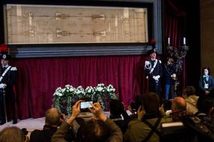 Above, pilgrims visit the exposition of the Shroud of Turin in Turin, Italy, on April 18, 2015. Below, an exhibit on the shroud on Sept. 12, 2017. 