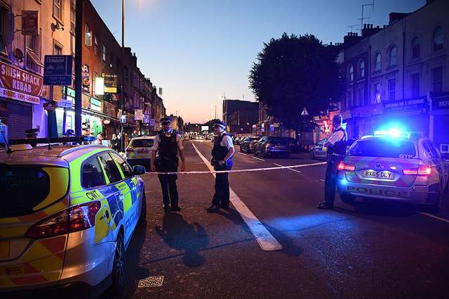 Police officers guard a road leading to Finsbury Park Mosque after a van hit worshippers outside the building on June 19 in London.