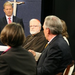 Cardinal Sean O'Malley and John Garvey (with back to camera) participate in religious freedom discussion in Boston.