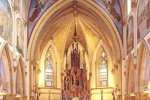 In this photograph of the sanctuary of St. John’s in Orange, NJ, you can see both of the images I refer to in my homily: the painting of Christ glorified in heaven over the arch (the subject is the coronation of the Blessed Virgin) and the large crucifixion scene behind the ambo. (In my homily I say the crucifixion is on my right. That’s because this is an older photograph; the ambo has been moved and the stairs retired. Other than that and some water damage to the ceiling, the church looks pretty much the same.)