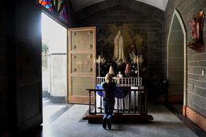 A Catholic prays at La Coromoto Church, in Caracas, Aug. 12.