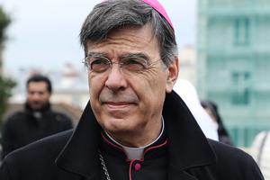 Archbishop of Paris Michel Aupetit attends a Stations of the Cross procession on Good Friday in front of Sacre Coeur Basilica on Montmartre hill in Paris, March 30, 2018.
