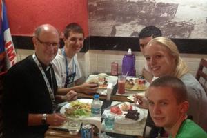 Bishop Conley enjoys lunch with WYD pilgrims. 