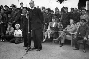 Father Edward Flanagan, founder of Boys Town, Nebraska, speaks into a microphone at Meiji Stadium in Tokyo May 28, 1947, during a Japanese Boy Scout jamboree. At right, wearing his school uniform, is Crown Prince Akahito.

