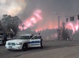 Policemen prepare to pull back June 11 from the inferno's edge, about one mile north of Our Lady of the Pines parish in Colorado Springs, Colo.