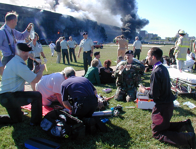 ABOVE: Father Stephen McGraw at the Pentagon, Sept. 11, 2001. INSET: Supplies are distributed at St. Dominic Parish, Panama City, Florida.