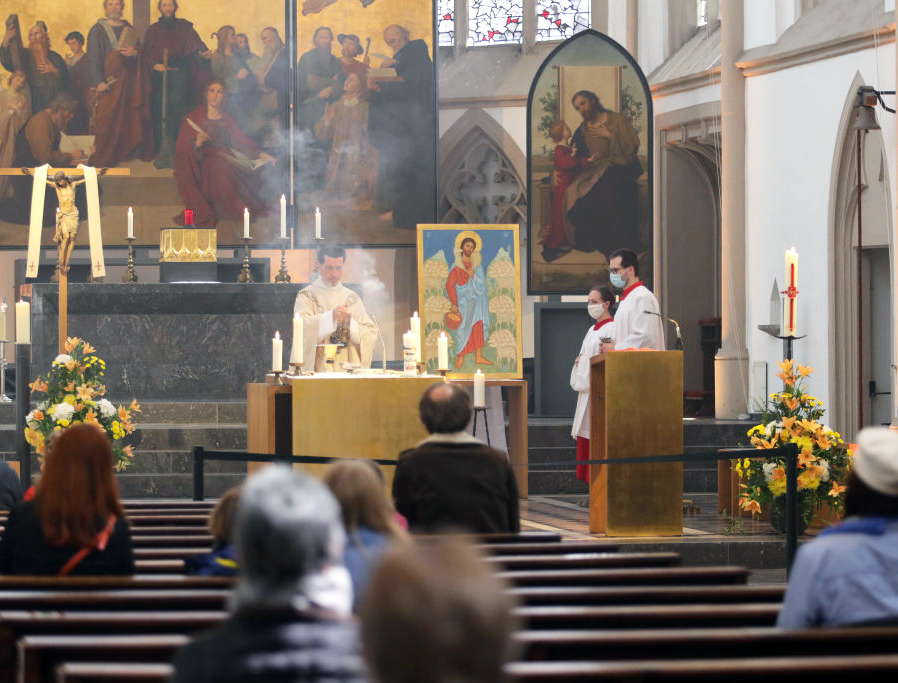 A limited number of people, wearing protective face masks, attend Sunday Mass May 3 at St. Remigius Catholic church in Bonn, Germany, for the first time since the novel coronavirus crisis began. Nationwide state and local governments are easing lockdown measures imposed in March to help stem the spread of the virus.