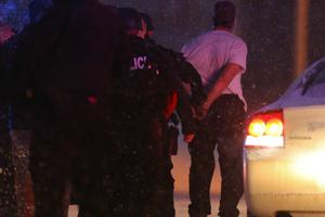 Suspect Robert Dear is led away in handcuffs by police following a deadly mass shooting Nov. 27 outside a Planned Parenthood facility in Colorado Springs, Colo. The alleged killer has no known connection with local pro-life advocates.