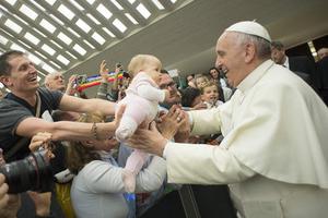Above, Pope Francis embraces a baby on April 30 at the Vatican; below, Pope Francis greets a family at Our Lady of the Assumption Cathedral in Santiago de Cuba, Sept. 22. 


