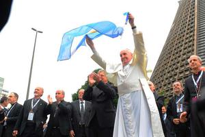 Pope Francis waves an Argentine flag July 25, 2013. 