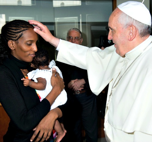 Pope Francis blesses Meriam Ibrahim, who is holding her daughter, Maya, July 24 at the St. Martha residence at the Vatican. The Sudanese woman who was sentenced to death in Sudan for refusing to recant her Christian faith has arrived in Italy, along with her family, including the infant born in prison.